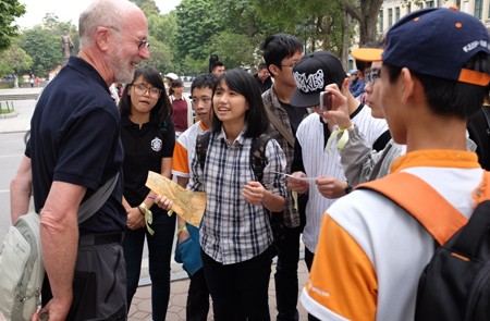 Students communicating with tourist in Hanoi