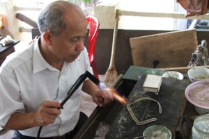 Artisan making jewelry products in Dinh Cong Jewelry Village