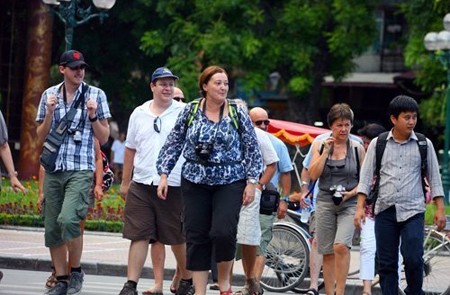 Foreigners crossing the road in Hanoi