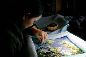 A woman making embroidery product in Quat Dong Village