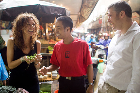 Tourists with guide in local market with Highway 4 Cooking Class