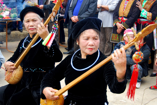 Tay women playing traditional intrument