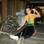 Thai woman weaving in her traditional house in the village