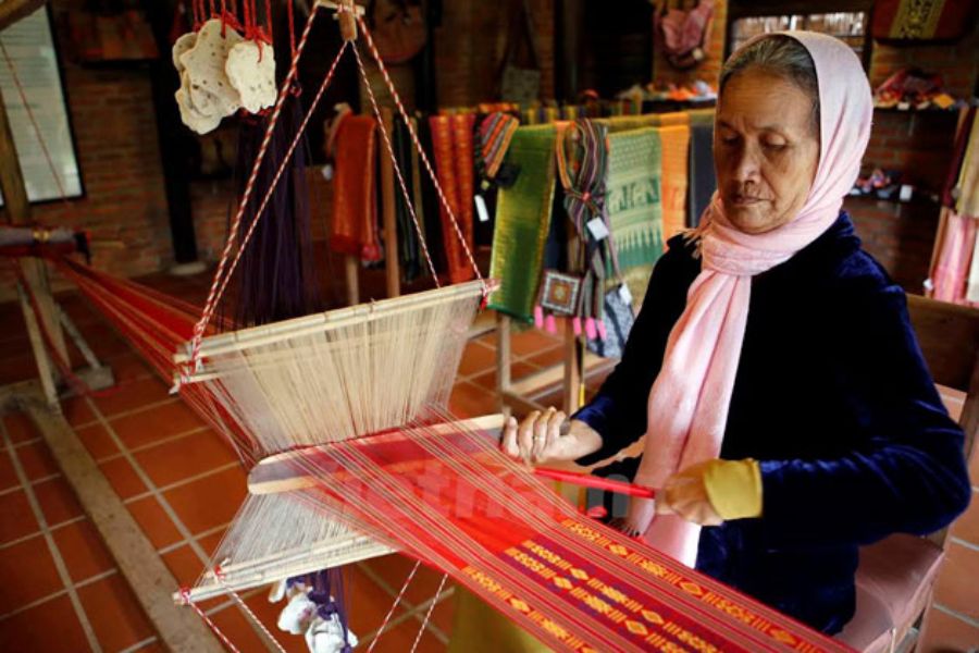 Artisan working at a silk loom in Van Phuc village