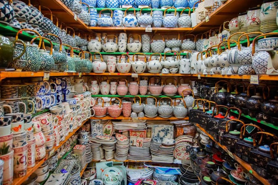 Unglazed ceramic vessels arranged on workshop shelves in Bat Trang